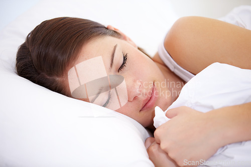 Image of Sleep, face and tired woman in a bed with peace, comfort and resting at home in a weekend. Calm, dreaming and female person sleeping in a bedroom for break, relax or burnout and fatigue recovery