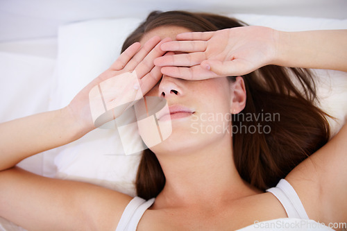 Image of Fatigue, wake up or tired woman in bed with hands on eyes frustrated with insomnia, crisis or disaster. Bedroom, burnout or lady person in house with sleeping issue, struggle or low energy from above