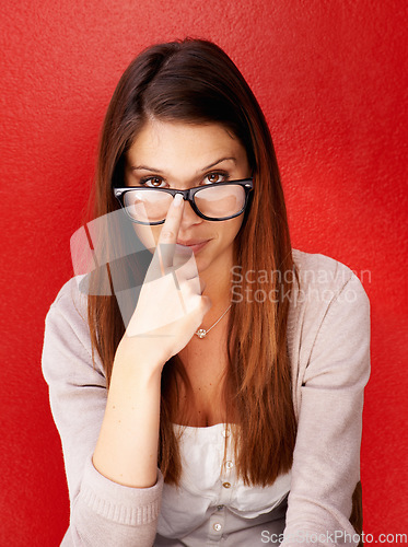 Image of Portrait, woman and fix glasses for vision, optometry and eye care health isolated on a red studio background. Face, person adjust spectacles and frame, prescription lens correction or ophthalmology