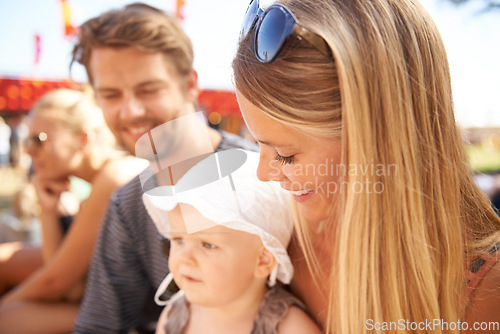 Image of Man, woman and baby at outdoor festival for nature event or childhood development, connection for bond. Mother, father and kid as family for summer outing or holiday travel, vacation or weekend fun