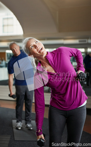 Image of Senior fitness, dumbbells and people stretching at gym for training, wellness and cardio exercise. Class, workout and elderly men with old personal trainer for weightlifting, support or bodybuilding