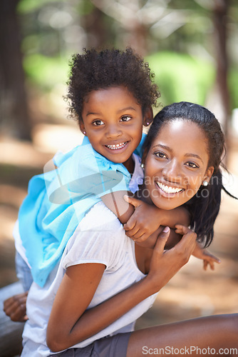 Image of Child, happy mother in portrait and piggyback outdoor, care or bonding together. Face, African mom carrying kid and smile in nature, family play in forest or park, love of parent and summer vacation