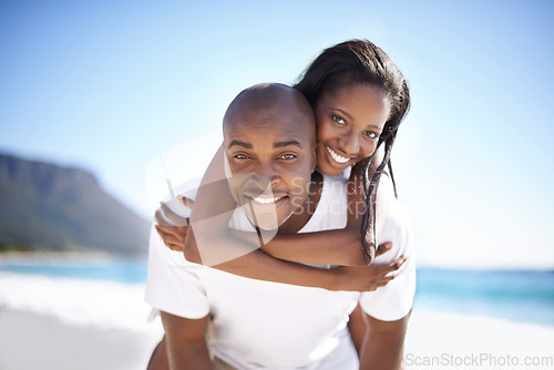 Image of Happy, piggyback and portrait of black couple at beach for valentines day vacation, holiday or adventure. Smile, love and young African man and woman on a date by the ocean on weekend trip together.