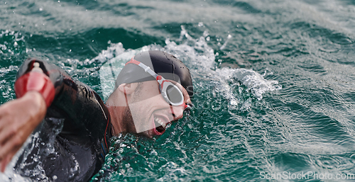 Image of A professional triathlete trains with unwavering dedication for an upcoming competition at a lake, emanating a sense of athleticism and profound commitment to excellence.