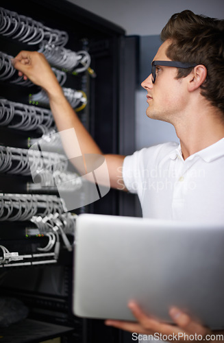 Image of Server room, information technology and man with laptop, check connectivity and night job. Cybersecurity system, it network or person for internet, data center and storage with cables for database