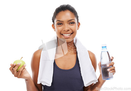 Image of Portrait, apple and water for fitness with a woman in studio isolated on a white background for health. Exercise, smile and towel with a confident young athlete at the gym for training or nutrition