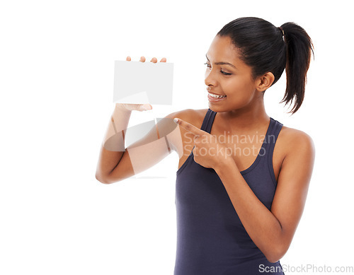 Image of Smile, space and a woman pointing to an empty card in studio isolated on a white background for information. Advertising, marketing or contact us with a happy young person holding a piece of paper