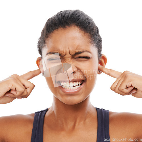 Image of Face, sound and fingers in ears with an eyes closed woman in studio isolated on a white background. Stress, anxiety or loud with a frustrated young person feeling unhappy or overwhelmed by noise