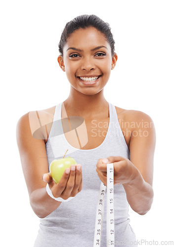 Image of Woman, portrait and lose weight with a measuring tape and apple in white background or studio. Happy, model and healthy food for results in fitness, wellness and diet with nutrition and fruit