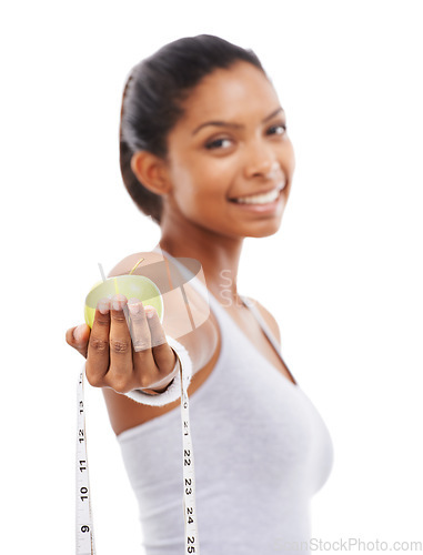 Image of Apple, tape measure and lose weight with happy woman in white background or studio. Indian, model and portrait with healthy food for results in fitness, wellness and diet with nutrition and fruit