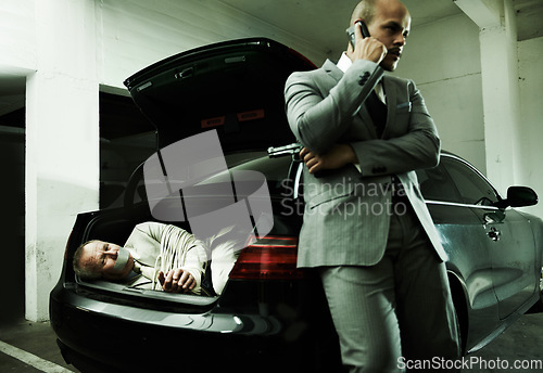 Image of Phone call, car and man with hostage in trunk for negotiation, kidnapping danger and crime. Mafia, gangster criminal and business person in boot for financial crisis, debt and payment in parking lot