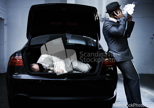 Image of Crime, car and man with hostage in trunk for negotiation, kidnapping ransom and phone call. Mafia, gangster criminal and businessman smoking in boot for abduction, danger and robbery in parking lot