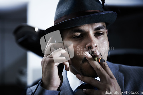 Image of Gangster, phone call and mafia for danger crime planning ransom, abduction or interrogation terror. Male person, cigar smoking and mobile device for hitman threat conversation, robbery or violence