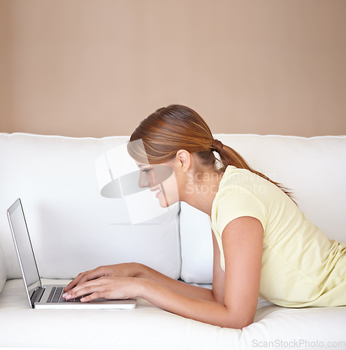 Image of Woman, smile or typing on laptop at sofa to update blog post, social media or digital subscription for remote work. Profile, happy freelancer or computer for online shopping, email or relax at mockup