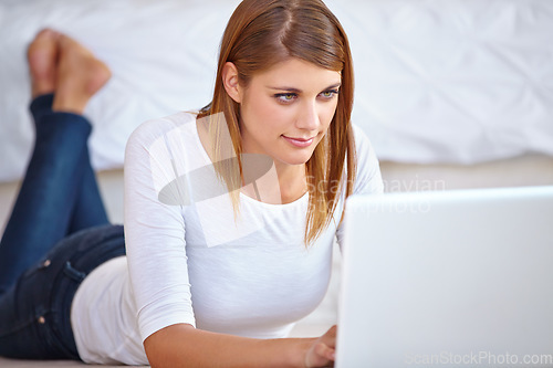 Image of Woman, remote work and relax on floor with laptop to update blog post, social media and digital news subscription at home. Freelancer typing on computer for online shopping, editing email or research