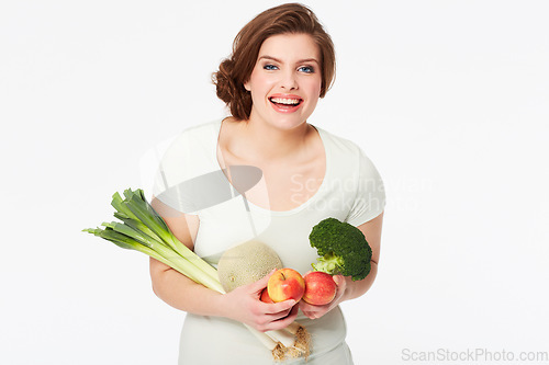 Image of Woman, happy and portrait with vegetables in studio, nutrition and wellness for vegan diet in mock up. Person, smile face and fruit for food, vitamins and detox in nutritionist by white background