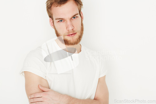 Image of Man, portrait and confident or fashion in studio with casual style, trendy outfit and calm expression. Person, face and relaxing, t-shirt and satisfaction with peace and pride on white background