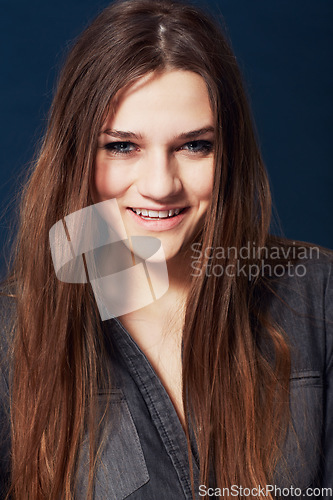 Image of Portrait, beauty and smile with a natural woman in studio on a dark background for wellness at the salon. Face, hair or skincare and a confident young model looking happy with makeup or cosmetics