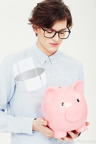 Image of Piggy bank, thinking and man with finance, business and planning isolated on a white studio background. Person, model and entrepreneur with savings, transactions and investment with payment and ideas