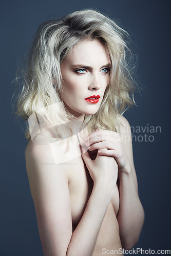 Image of Beauty, nude and woman on blue background with makeup, cosmetics and red lipstick in studio. Model, aesthetic and person with frizzy hairstyle, naked and sexy with confidence, pride and art deco