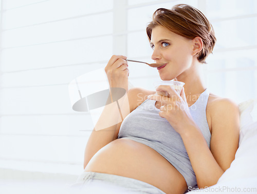 Image of Breakfast in bed, eating and pregnant woman with chocolate pudding in a house, calm and hungry. Sugar, face and female person in bedroom with pregnancy nutrition for health, balance or utero wellness