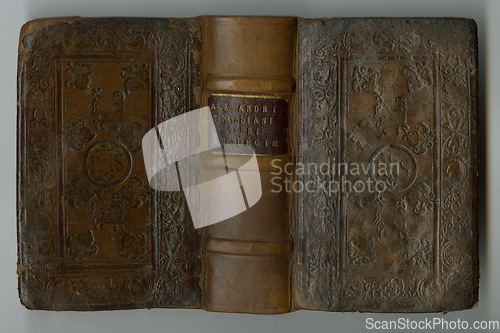 Image of Old book, vintage and cover of manuscript, ancient scripture or antique literature against a studio background. Closeup of blank historical novel, journal or worn guide of history, study or research