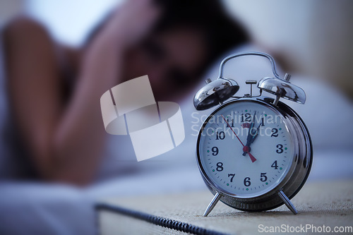 Image of Alarm, clock and frustrated woman in a bed with hands on ears for noise, sound or alert at home. Time, bell and female person in a bedroom blur with fatigue, burnout or sleeping late from insomnia