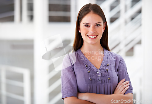 Image of Portrait, smile and a business woman arms crossed in her office as a company intern at the start of her career. Mindset, confident and a happy young employee in a creative agency as a designer