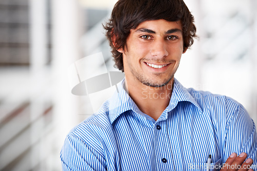 Image of Portrait, smile and a business man arms crossed in his office for an internship as a confident designer. Face, mindset and a happy young employee in a company workplace or startup design agency