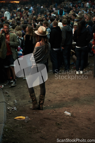 Image of Back, music festival and a woman in the crowd of a concert at night for an event, show or performance. Party, carnival and a person in the audience of a social gathering for live entertainment