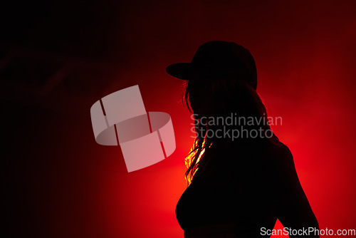 Image of Woman, red light and silhouette at party concert or festival night, stage event or dark. Female person, strobe and glow for artistic creative shadow for dance rave, entertainment or mockup background