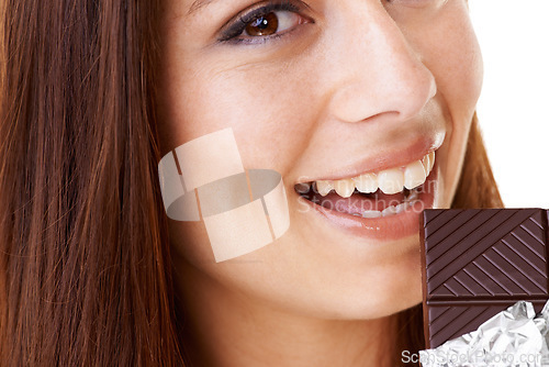 Image of Happy, eating and portrait of woman with chocolate in a studio for dessert with positive attitude. Smile, face and closeup of young female person enjoying candy for snack isolated by white background