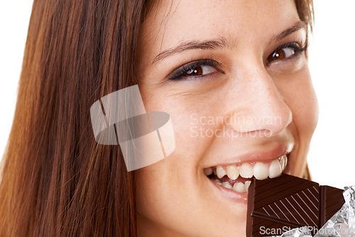 Image of Smile, eating and portrait of woman with chocolate in a studio for dessert with positive attitude. Happy, face and closeup of young female person enjoying candy for snack isolated by white background