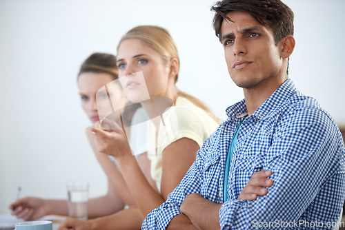 Image of Serious, meeting and arms crossed with documents, teamwork and planning design strategy with workers. Man, women and tech for email, work or project for conversation, workplace and professional