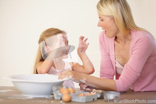 Image of Kitchen, baking and happy family playing, love and home mother and daughter bond, have fun and prepare recipe ingredients. Smile, goofy mama and silly kid learning cooking together with playful mom