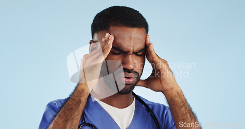 Image of Doctor, dizzy or man in studio with headache, head pain or fatigue in medical healthcare crisis or emergency. Depression, face or tired male nurse with burnout, migraine or stress on blue background