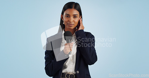 Image of Woman, portrait or tv reporter in studio talking, speaking on talk show or media on blue background. Breaking news, press or Indian presenter presenting live global political events with microphone