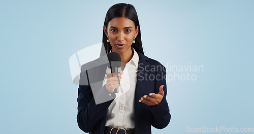 Image of Woman, portrait or presenter in studio talking, speaking on talk show or media on blue background. Breaking news, tv press or Indian reporter presenting live global political events with microphone