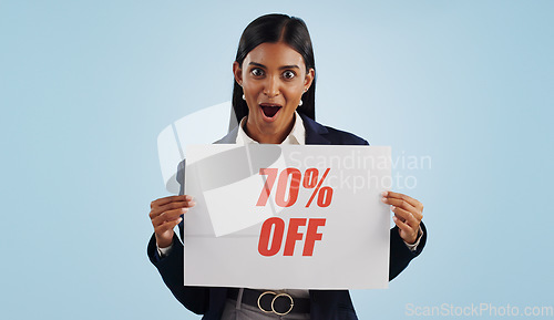 Image of Happy woman, portrait and sale sign for advertising, discount or deal against a blue studio background. Female person with billboard or poster for marketing, promotion or special on mockup space