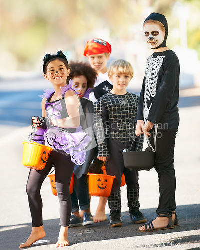 Image of Children, halloween or trick and treat portrait outdoor in neighborhood for fun and dress up. A group of young kids together for happiness, celebrate holiday and diversity with candy or sweets