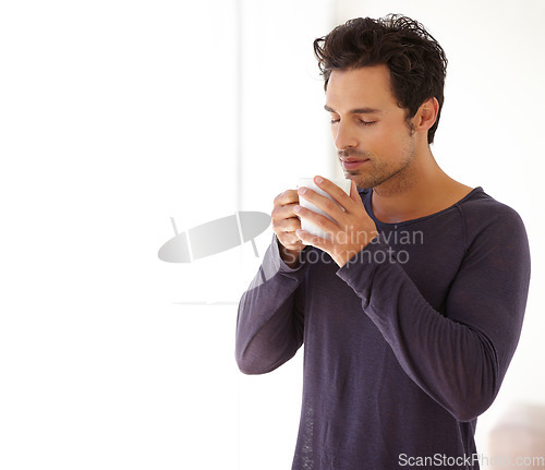 Image of Man, coffee and face with aroma or smile in the morning for relax, peace and satisfaction at home. Person, happy and thoughtful with espresso, beverage or hot chocolate for smell, wellness or ideas