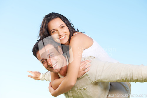 Image of Happy couple, portrait and piggyback with love, marriage and enjoying a break on holiday, smile and funny. Playful, vacation and honeymoon for having fun, carefree and romantic relationship