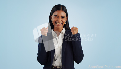 Image of Winner, excited or happy woman in celebration for a business deal isolated on blue background. Wow, goals or proud Indian lady with smile, victory success or reward in entrepreneurship or studio