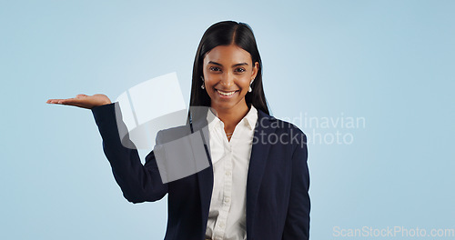 Image of Portrait of businesswoman, studio or palm for investment deal, financial offer or product mockup space. Hand, smile or happy Indian corporate lady on blue background marketing, advertising or finance
