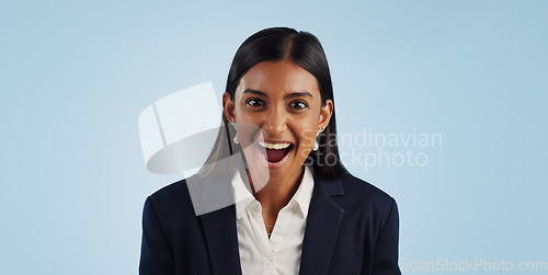 Image of Surprise, excited or portrait of woman in celebration for a business deal on blue background. Wow, goals or shocked Indian lady with smile, victory success or reward in entrepreneurship or studio
