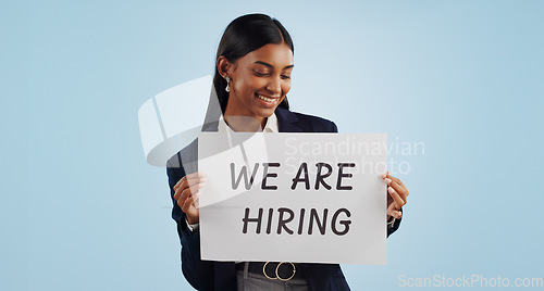 Image of Happy business woman, hiring and sign for advertising or opportunity deal against a blue studio background. Female person smile with billboard or poster for job recruiting or career on mockup space