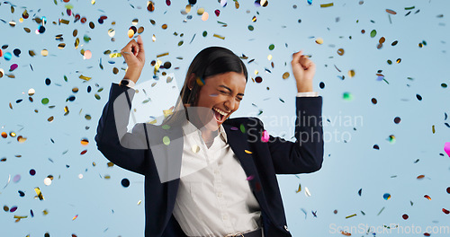 Image of Happy business woman, confetti and celebration for winning or promotion against a blue studio background. Excited female person or employee smile in freedom for victory, achievement or party event