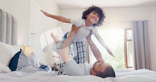 Image of Happy father, child and playing on bed for bonding, holiday or fun weekend together in morning at home. Dad lying, lifting or kid flying in bedroom for love, care or support in embrace at house