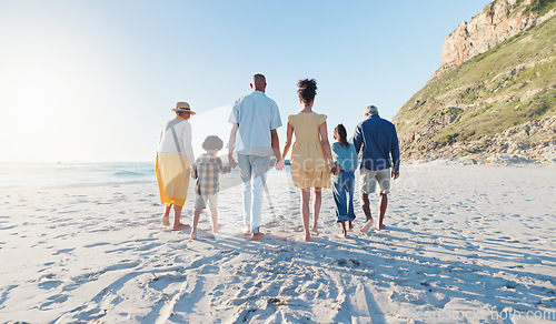 Image of Holding hands, walking and big family at the beach on holiday, adventure or vacation together. Love, travel and children with parents and grandparents on the sand by the ocean or sea on weekend trip.