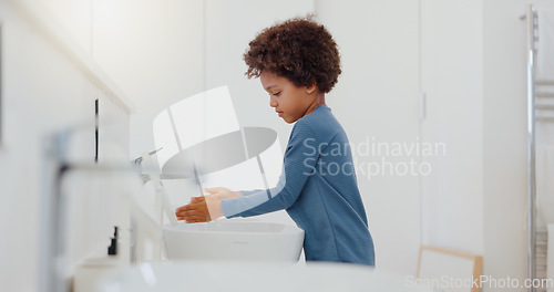 Image of Child, tap and washing or cleaning hands for hygiene, bacteria or germ removal in sink at home. Little boy or kid rinsing soap in bathroom, water or basin for disinfection or cleanliness at house